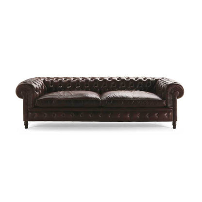Vintage dark brown Chesterfield 3-seater leather sofa with deep diamond button tufting, rolled scroll arms, plush seat cushions and classic British-inspired design, ideal for luxury living rooms, executive offices, boutique hotels and traditional interiors.