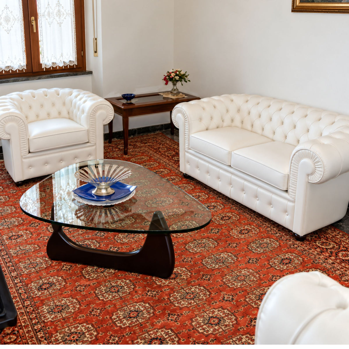 White Chesterfield 2-seater leather sofa with deep diamond button tufting, rolled scroll arms, plush seat cushions and classic British-inspired design, ideal for luxury living rooms, boutique hotels, executive offices and elegant contemporary interiors.