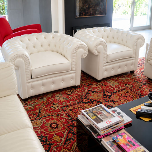 White Chesterfield leather armchair with deep diamond button tufting, rolled scroll arms, plush seat cushion and classic British design, perfect for luxury living rooms, executive offices, boutique hotels and elegant interiors.