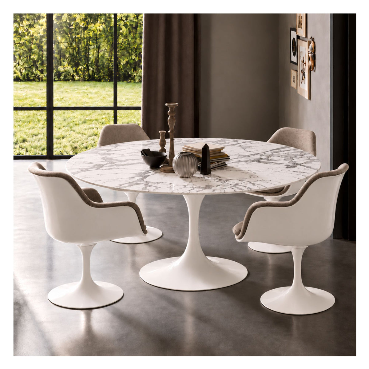White marble round Eero Saarinen Tulip dining table with a white pedestal base paired with four white Tulip armchairs featuring light grey upholstered cushions in a contemporary dining room.