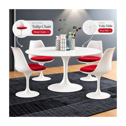 Round white Saarinen Tulip dining table paired with four white Tulip chairs featuring red upholstered seat cushions in a contemporary mid-century modern dining room.