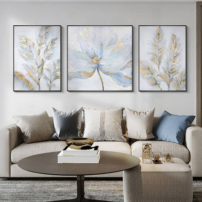 A set of 3 light-colored canvas paintings with golden flowers