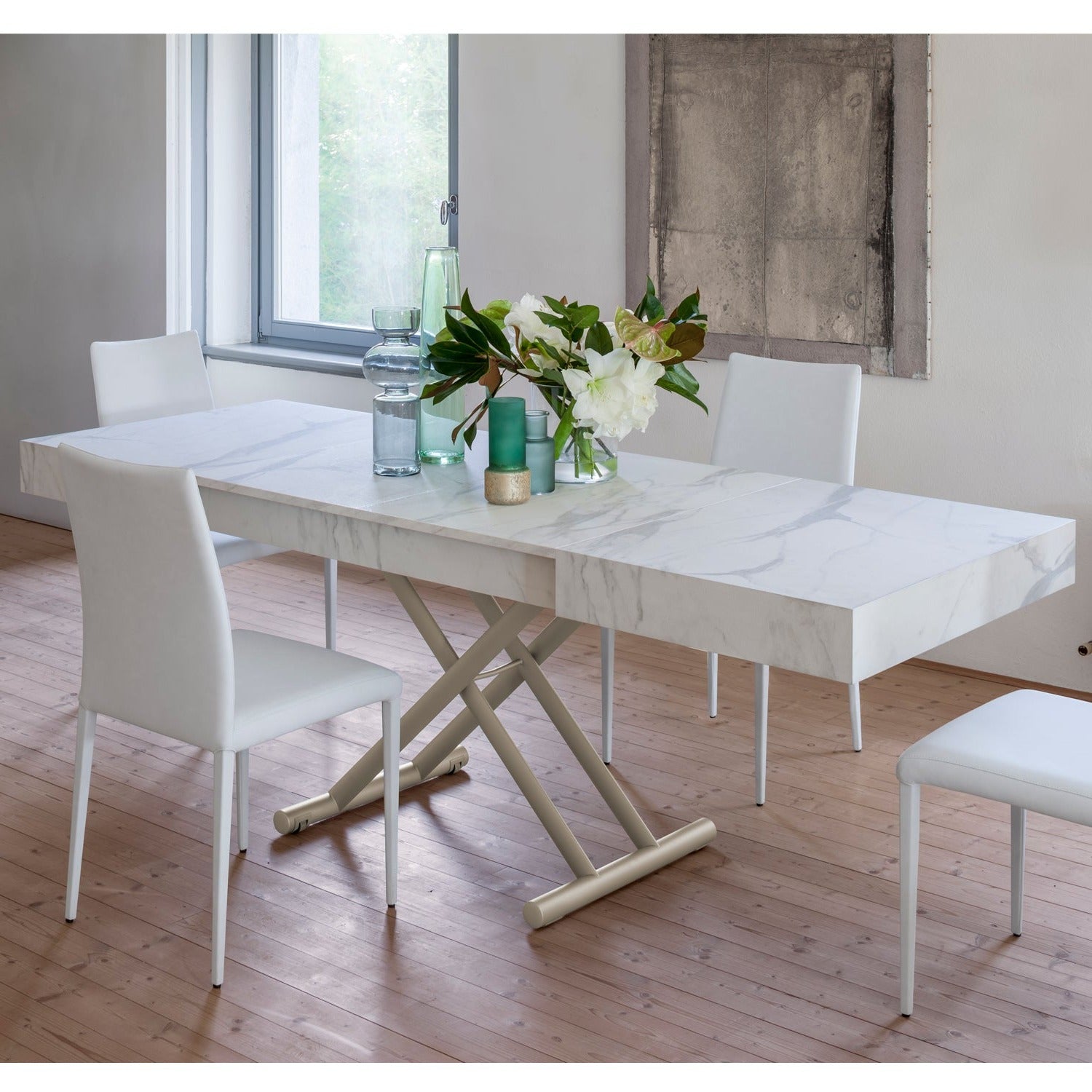 Ulisse convertible table by Altacom extended into dining table with marble effect top and chairs in modern interior