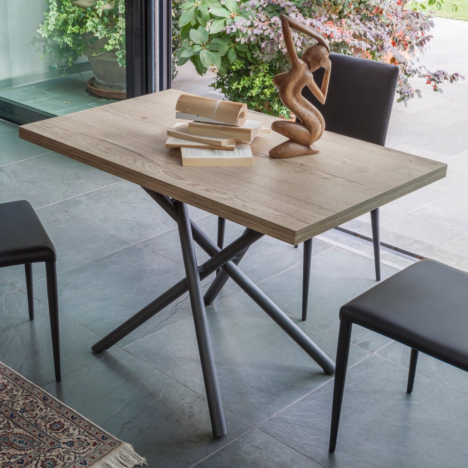 Altacom Lotus convertible table fully extended into dining table with chairs in modern interior