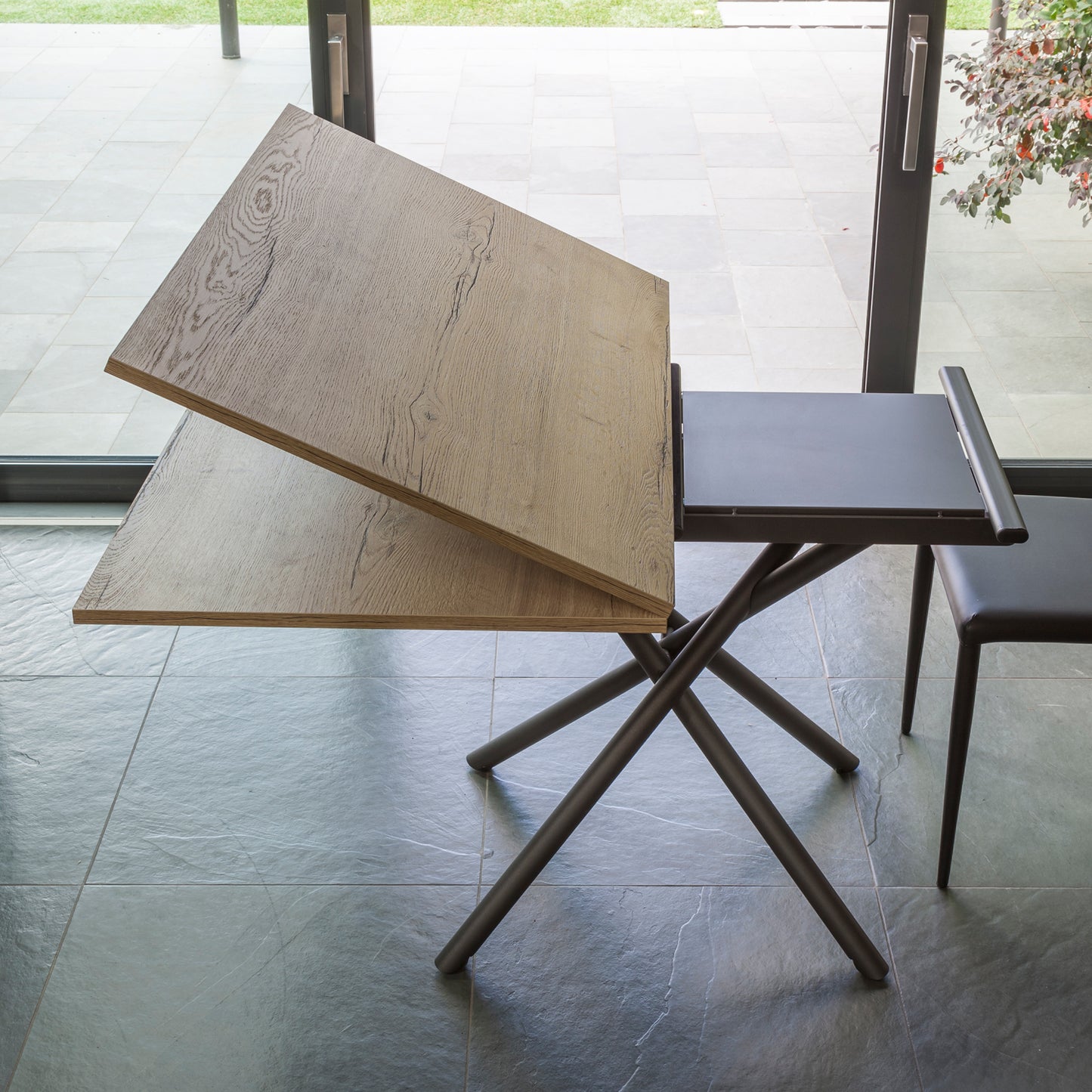 Altacom Lotus convertible table showing lift mechanism and internal extension leaf during transformation