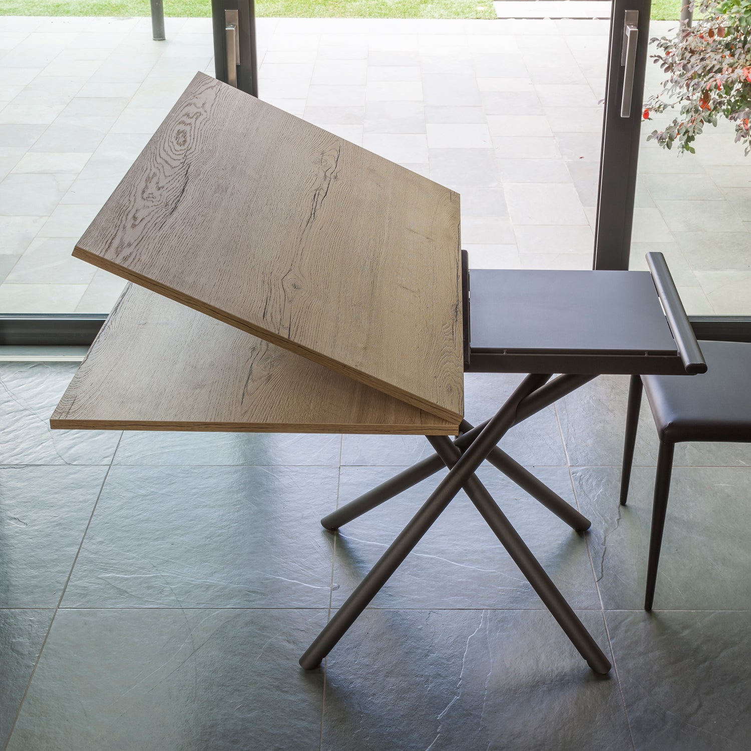 Altacom Lotus convertible table showing lift mechanism and internal extension leaf during transformation