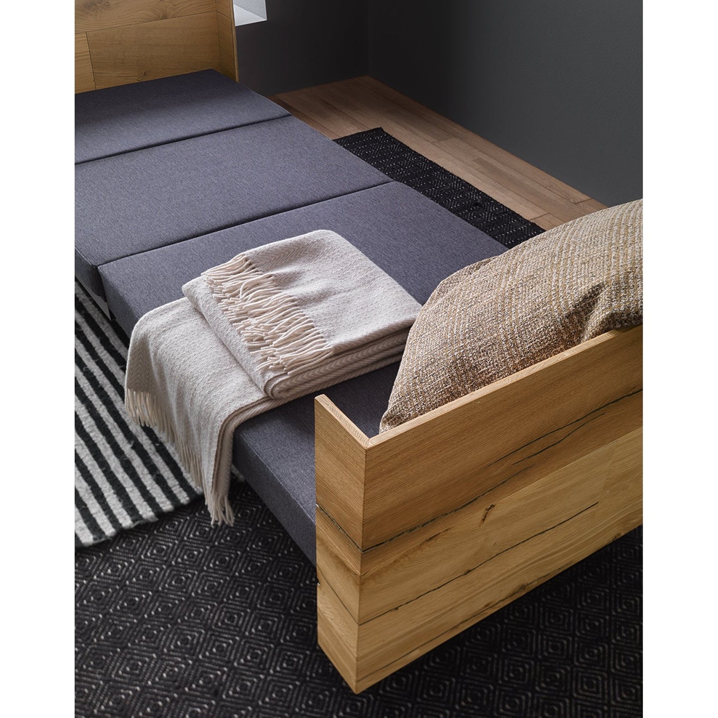 Altacom Tavoletto convertible table fully transformed into bed with mattress, blanket and pillow in modern living room