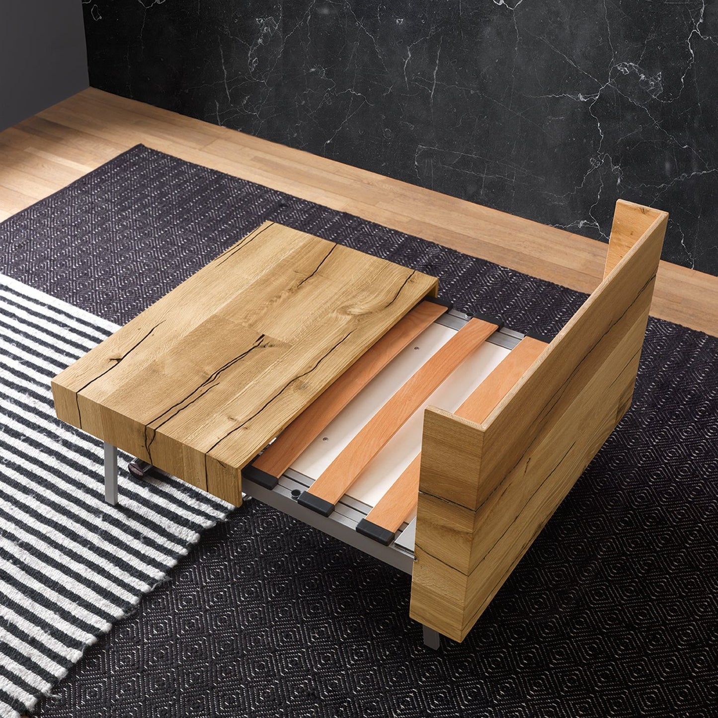 Altacom Tavoletto convertible table mid transformation showing tabletop sliding and bed structure extending