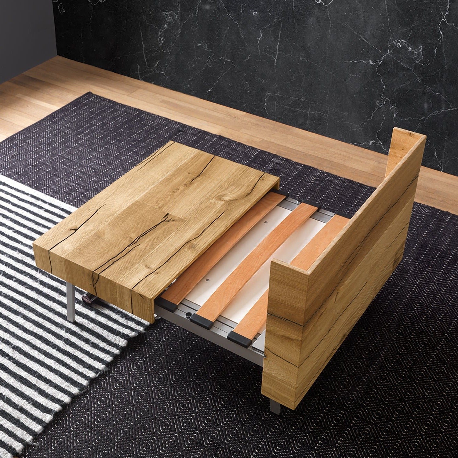 Altacom Tavoletto convertible table mid transformation showing tabletop sliding and bed structure extending