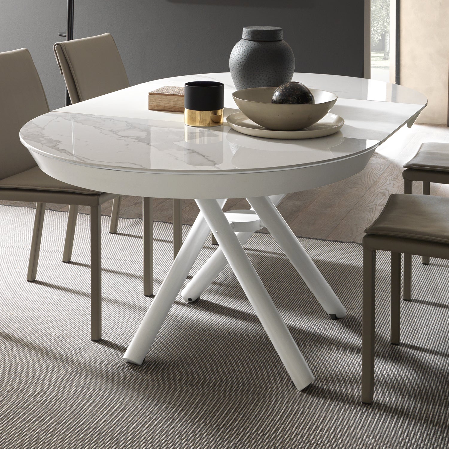 Helios extending dining table by Altacom with white marble-effect ceramic top and crossed white metal base
