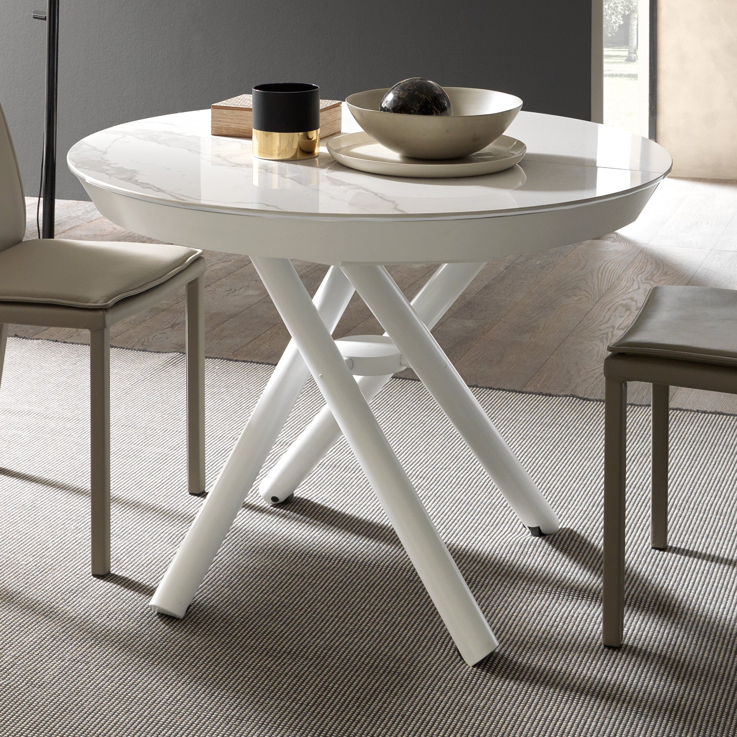 White Helios transforming dining table by Altacom with marble-effect ceramic top and crossed white metal base