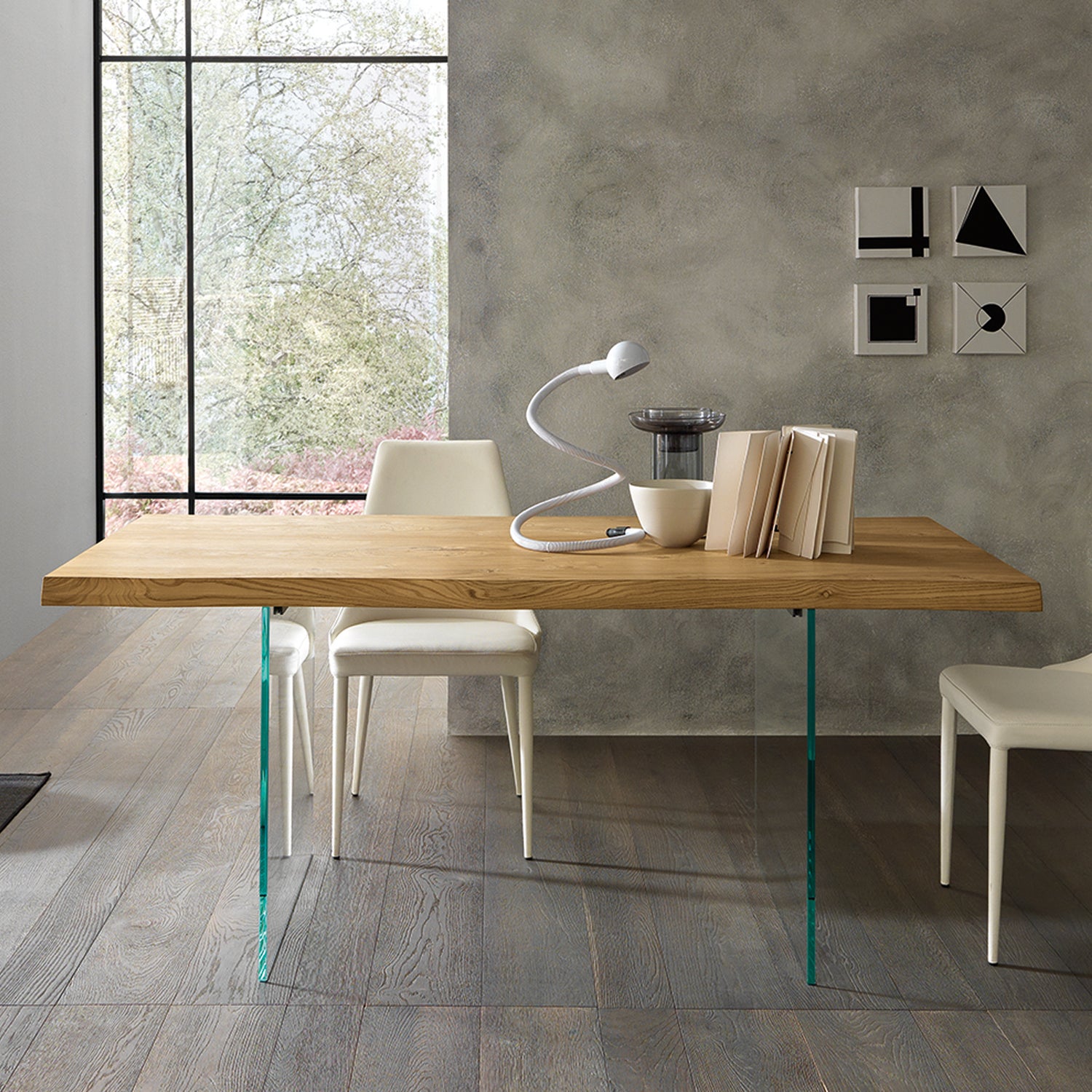 Meridiano dining table with glass legs shown in symmetrical modern interior composition highlighting floating design