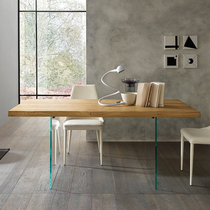 Meridiano dining table with glass legs shown in symmetrical modern interior composition highlighting floating design