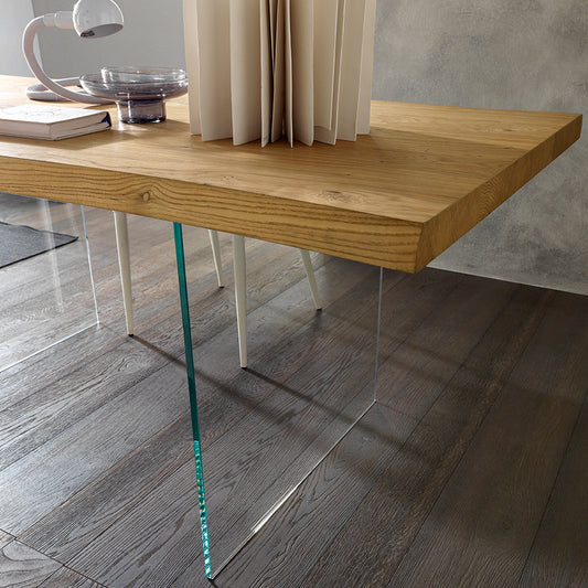 Meridiano dining table detail showing transparent glass legs and floating wood top effect by Altacom