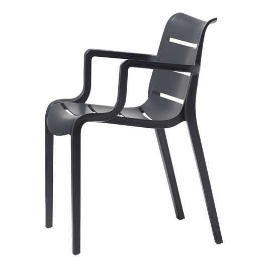 SCAB Sunset armchair in graphite shown from the side, featuring integrated armrests, a slatted backrest and a stackable weather-resistant technopolymer design for indoor and outdoor use