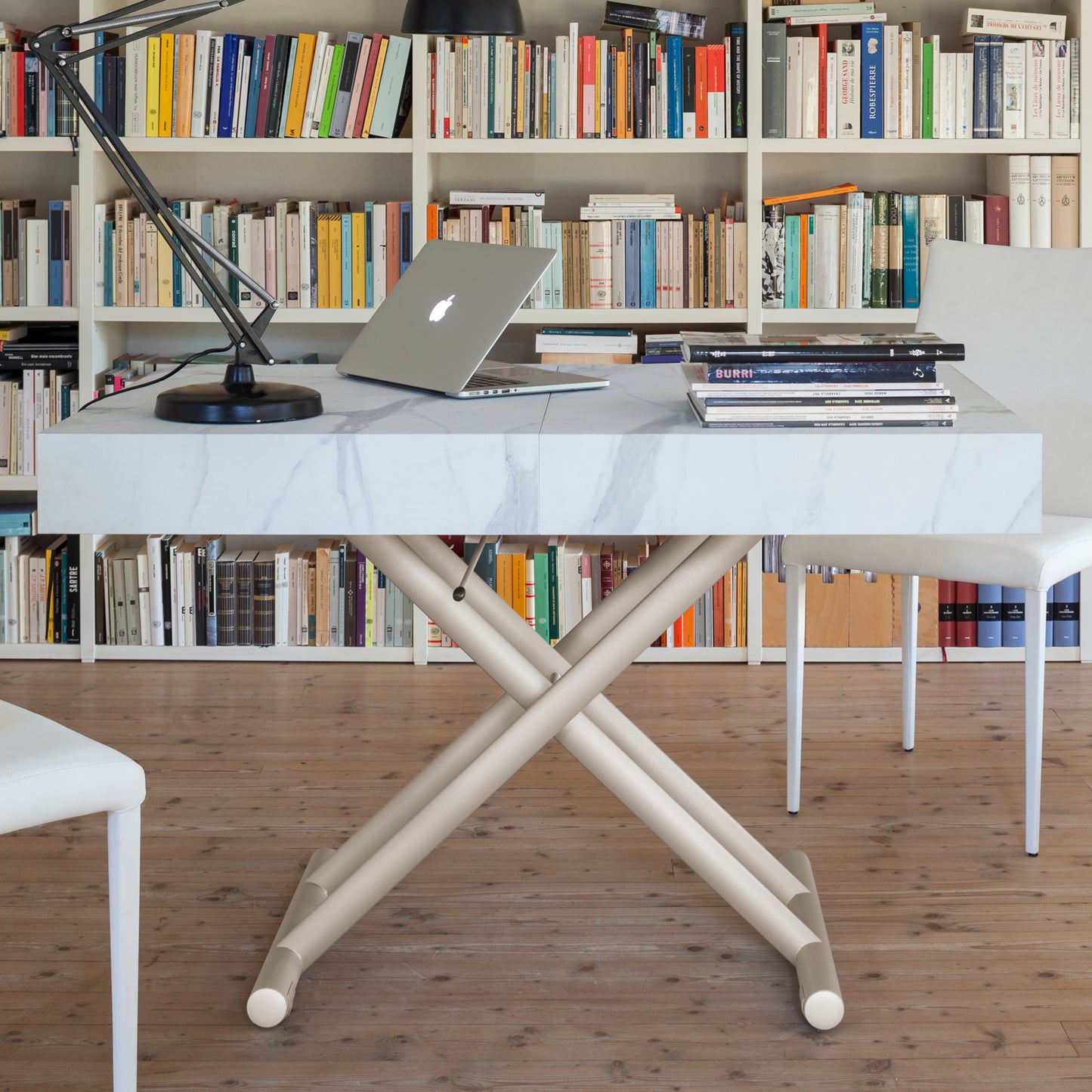 Ulisse convertible table by Altacom used as desk at dining height with laptop showing multi functional use