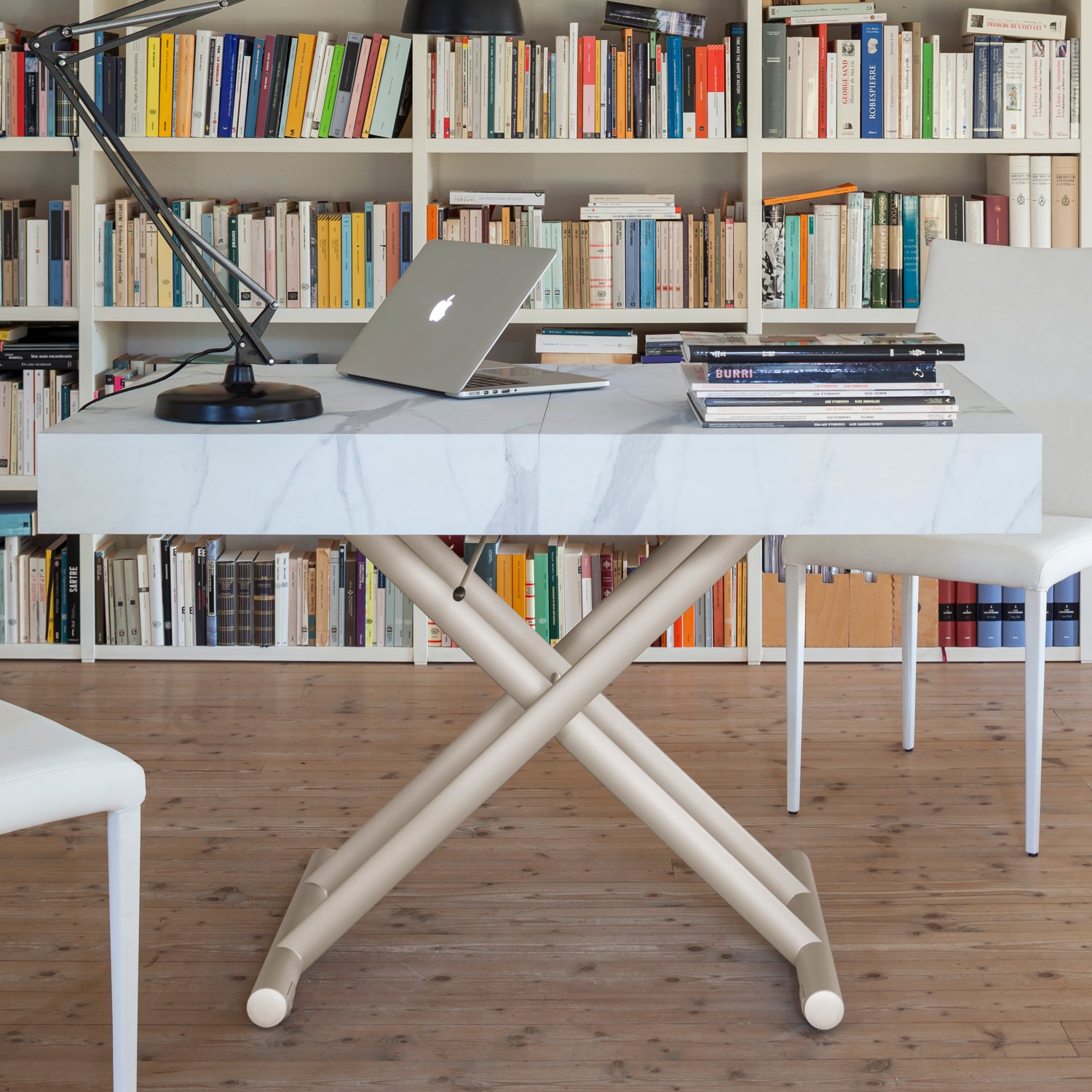 Ulisse convertible table by Altacom used as desk at dining height with laptop showing multi functional use